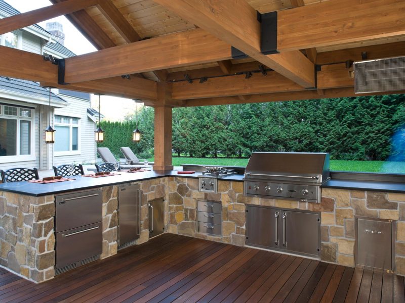 outdoor living space with covered structure and stone kitchen and outdoor grill